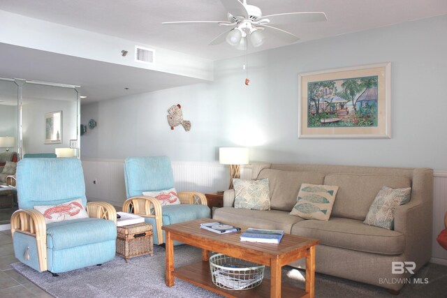 tiled living room with ceiling fan