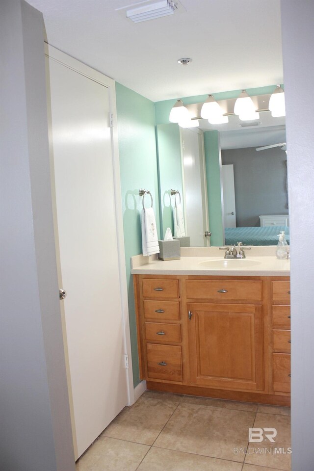 bathroom with tile patterned floors and vanity