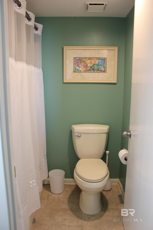 bathroom with tile patterned flooring and toilet