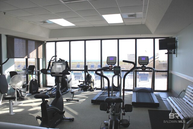 gym with a paneled ceiling