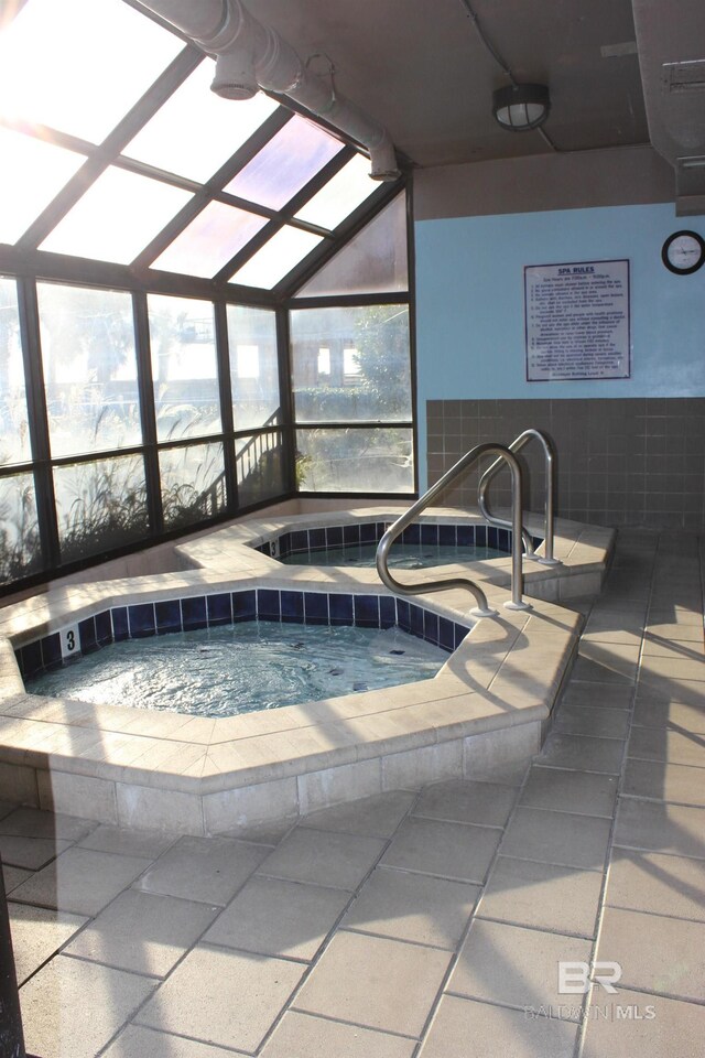 view of swimming pool with an indoor in ground hot tub