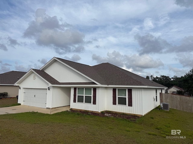 view of front of property with central AC, fence, concrete driveway, an attached garage, and a shingled roof