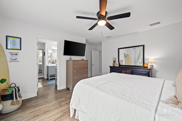 3931 Langley Ave, Foley, AL 36535 - bedroom with light wood-style floors, a ceiling fan, and connected bathroom