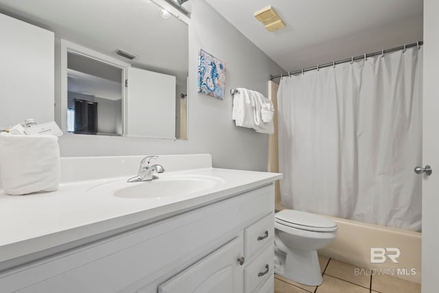 full bathroom with vanity, toilet, shower / bath combo with shower curtain, and tile patterned flooring