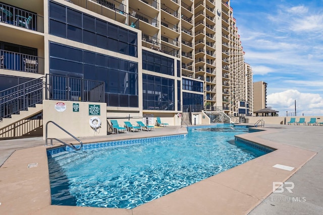 view of swimming pool with a patio