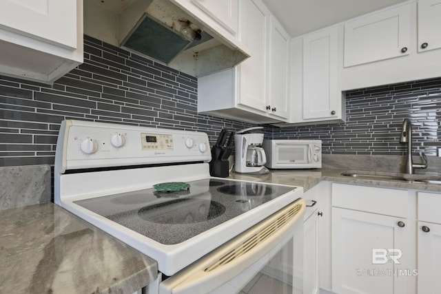 kitchen featuring white appliances and white cabinetry