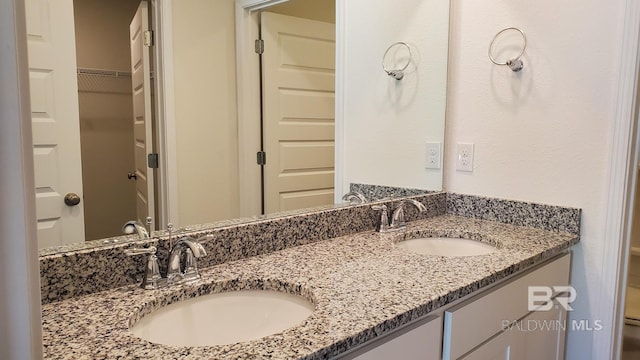 full bathroom featuring a sink and double vanity