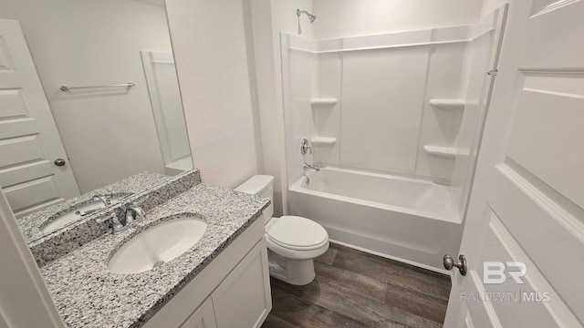 bathroom featuring shower / washtub combination, vanity, toilet, and wood finished floors