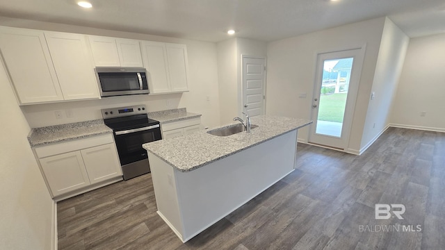 kitchen featuring recessed lighting, dark wood-style flooring, a sink, white cabinetry, and appliances with stainless steel finishes