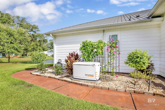 details featuring metal roof, a power unit, gutters, and a downspout