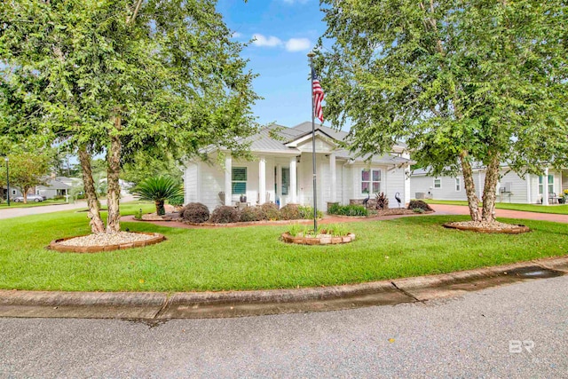 view of property hidden behind natural elements with a front lawn