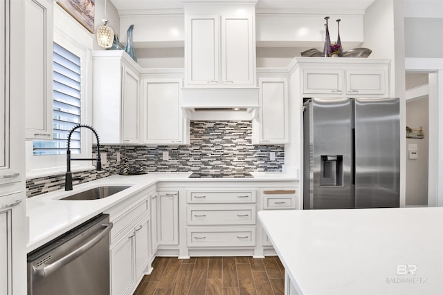 kitchen with a sink, tasteful backsplash, appliances with stainless steel finishes, and light countertops