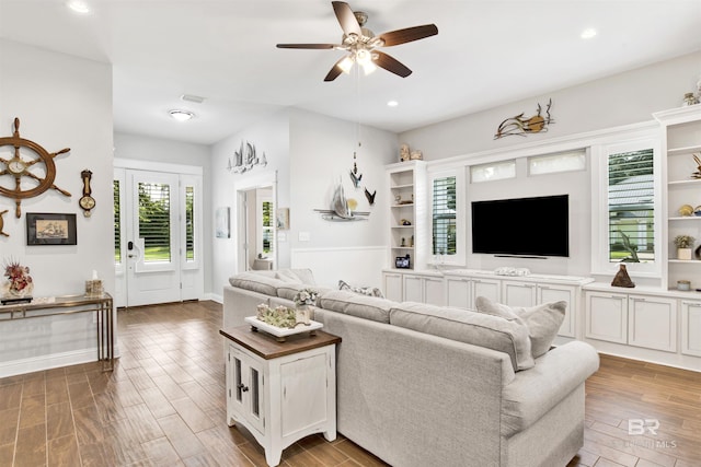 living area with recessed lighting, ceiling fan, and wood finished floors