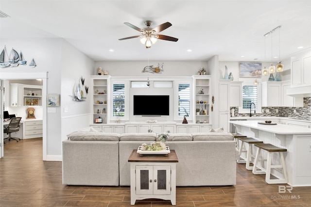 living area featuring plenty of natural light, recessed lighting, and wood finish floors