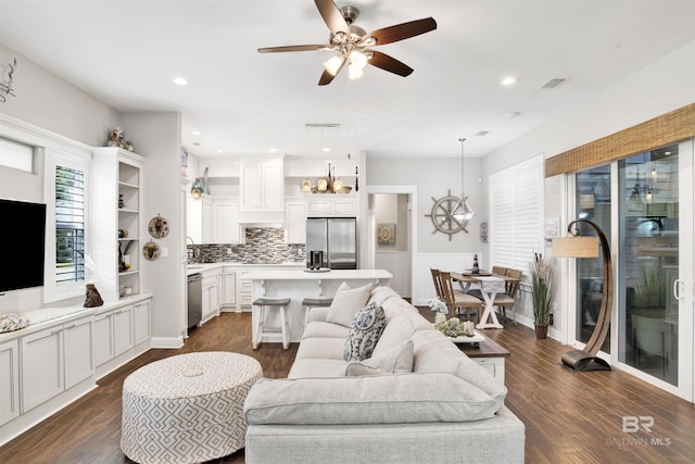 living area with visible vents, recessed lighting, ceiling fan, and dark wood-style flooring