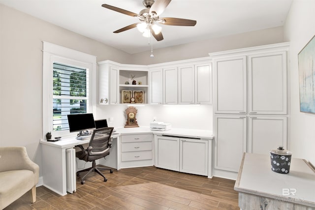 home office featuring wood finished floors and a ceiling fan