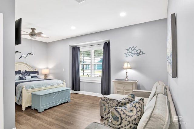 bedroom with recessed lighting, ceiling fan, baseboards, and wood finished floors