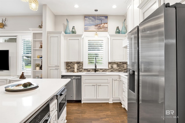 kitchen featuring a sink, light countertops, white cabinetry, and stainless steel appliances