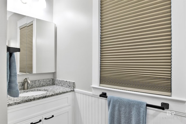 bathroom with vanity and wainscoting