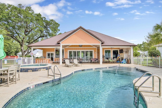 pool with fence, a hot tub, ceiling fan, and a patio area