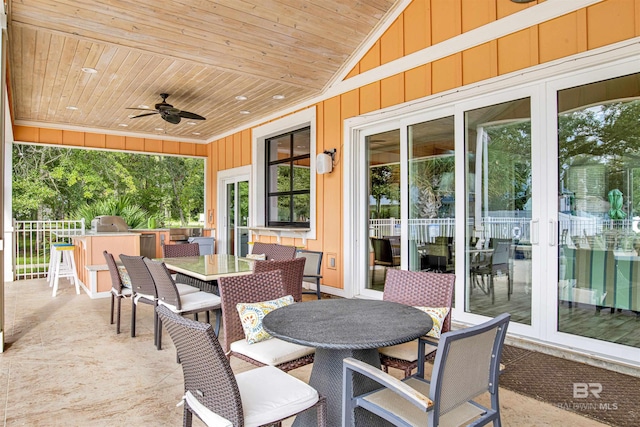 view of patio with outdoor dining space, exterior kitchen, and a ceiling fan