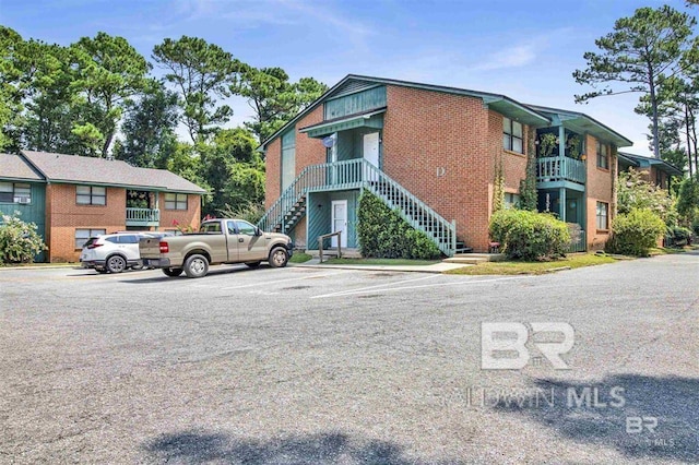 view of property with uncovered parking