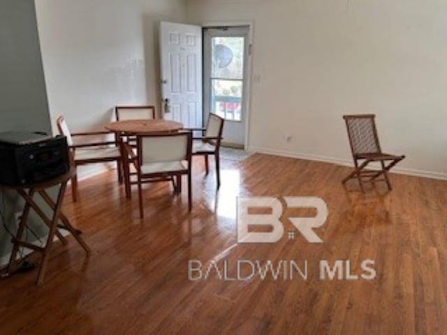 dining area featuring wood finished floors and baseboards