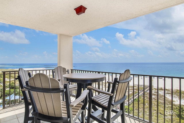 balcony featuring a water view and a view of the beach