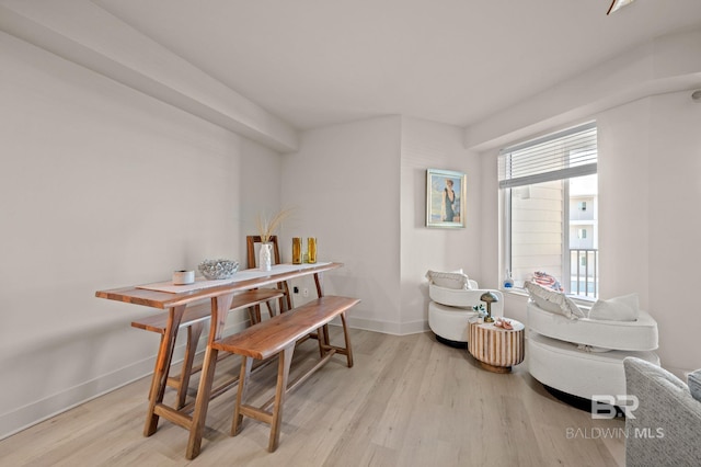 living area featuring wood finished floors and baseboards