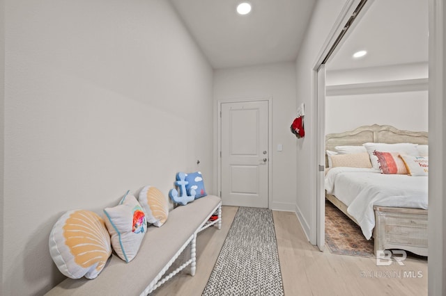 bedroom with baseboards, light wood finished floors, and recessed lighting