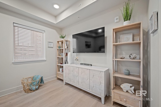 interior space with wood finished floors and baseboards