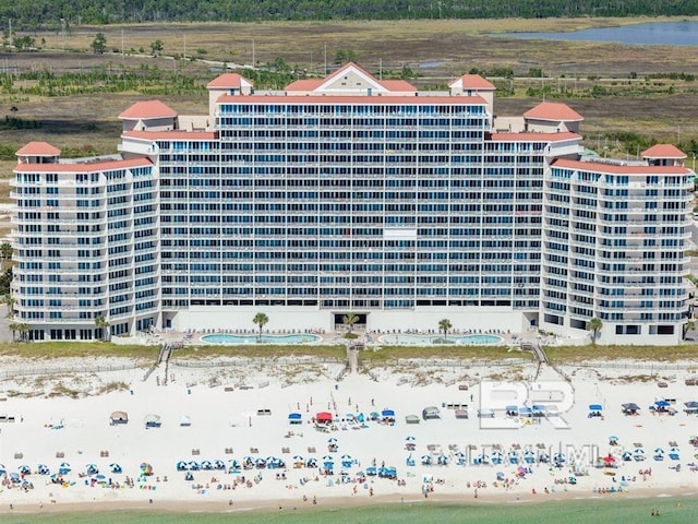 exterior space featuring a water view and a view of the beach