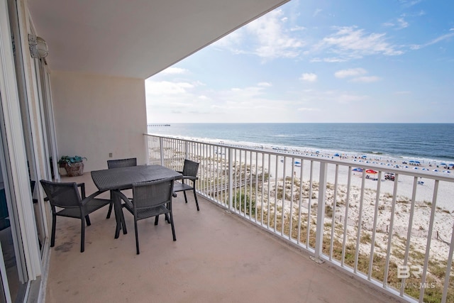 balcony with a water view and a beach view