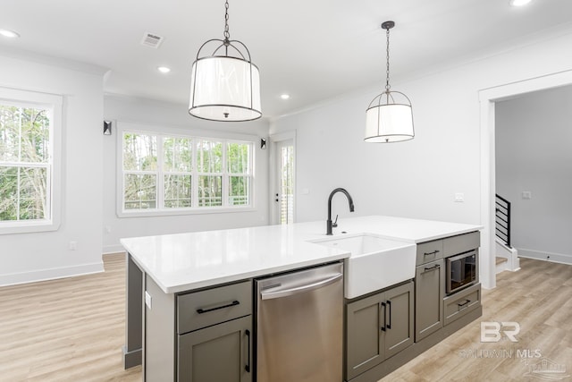 kitchen featuring stainless steel appliances, plenty of natural light, and gray cabinetry