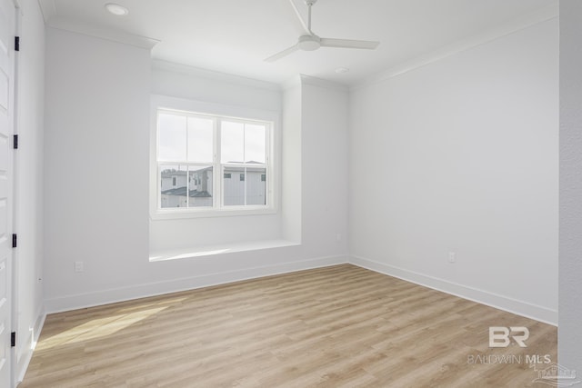 unfurnished room featuring light wood-style floors, baseboards, a ceiling fan, and crown molding