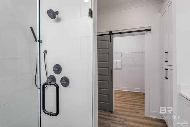 full bathroom with a shower stall, wood finished floors, and vanity