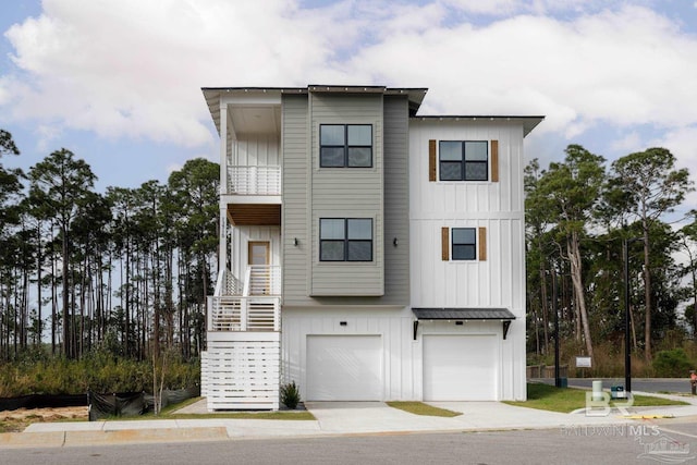 multi unit property featuring board and batten siding, a standing seam roof, a garage, and stairs