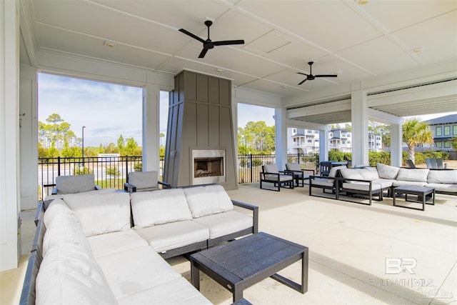 sunroom / solarium with a wealth of natural light, a fireplace, and a ceiling fan