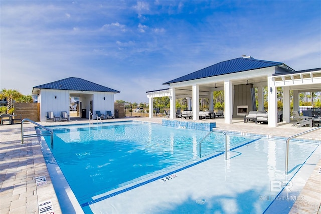 pool with ceiling fan, a storage structure, fence, an outdoor structure, and a patio area