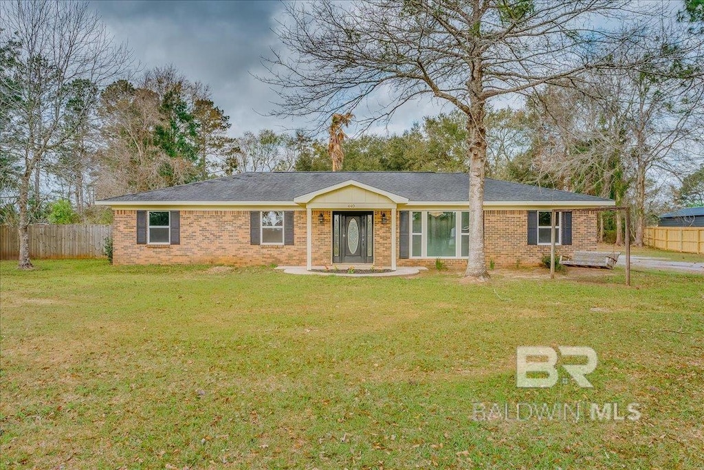 440 Dykes Rd, Mobile, AL 36608 - ranch-style house featuring brick siding, a front lawn, and fence