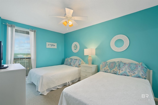 bedroom featuring ceiling fan and light carpet
