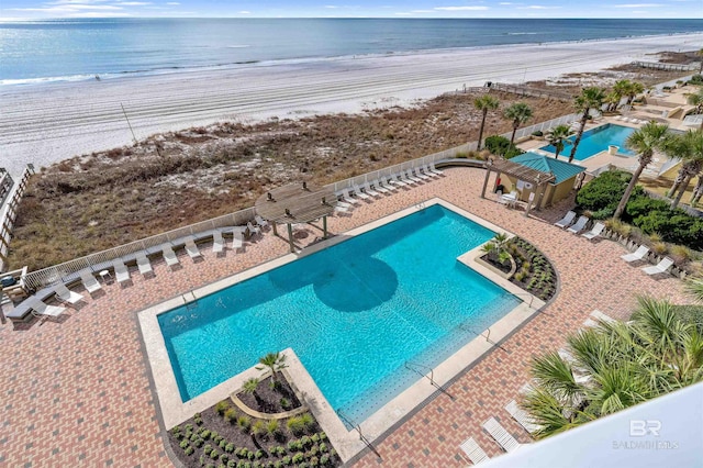 view of pool with a patio area and a water view