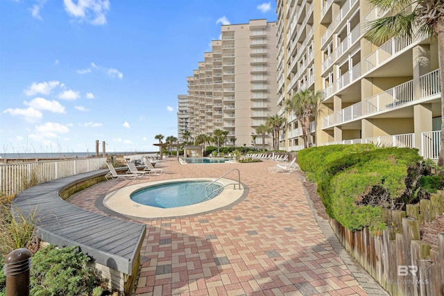 view of swimming pool with a community hot tub