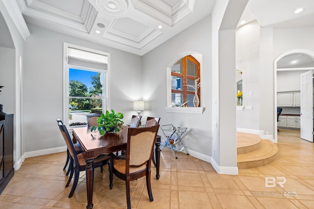 tiled dining room featuring ornamental molding, coffered ceiling, a towering ceiling, and beamed ceiling