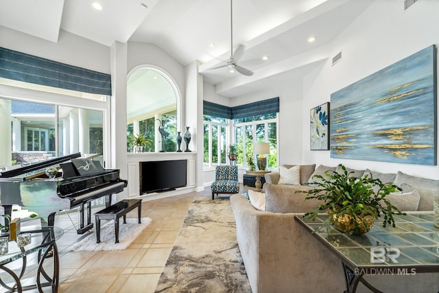 living room with lofted ceiling, light tile patterned flooring, and ceiling fan