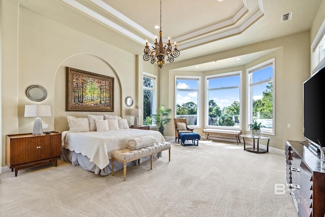 bedroom featuring a tray ceiling, crown molding, light carpet, and a notable chandelier