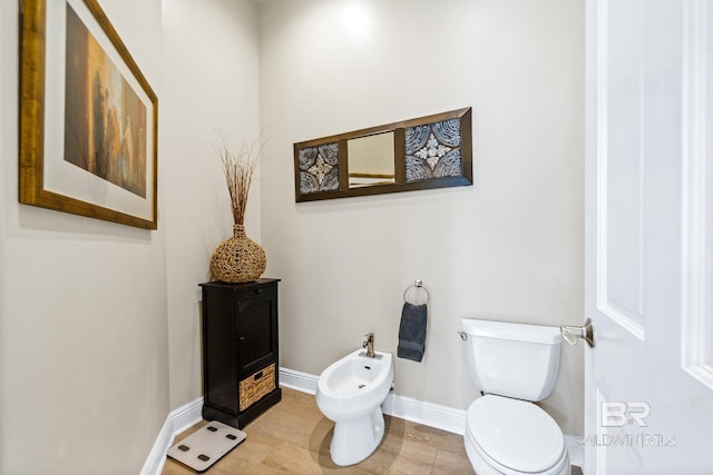 bathroom featuring toilet and a bidet