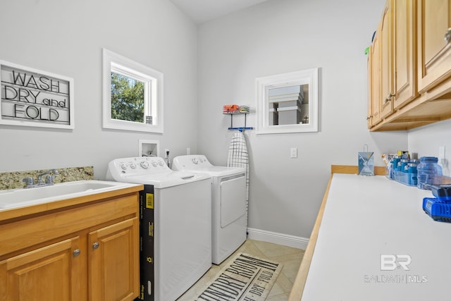 laundry area featuring cabinets, sink, independent washer and dryer, and light tile patterned flooring