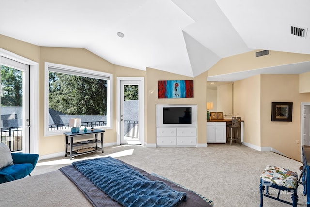 carpeted living room featuring lofted ceiling