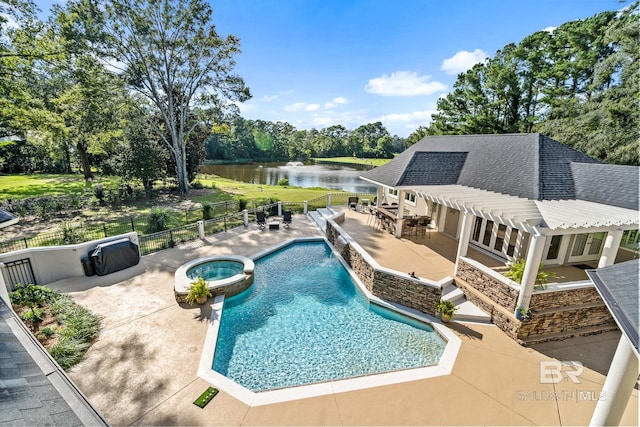 view of pool with an in ground hot tub, a patio, and a water view